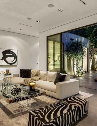 Modern living room with minimalist decor blending indoor and outdoor spaces.